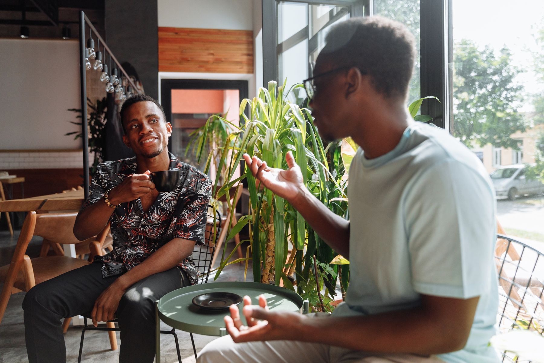 Two people talking over coffee